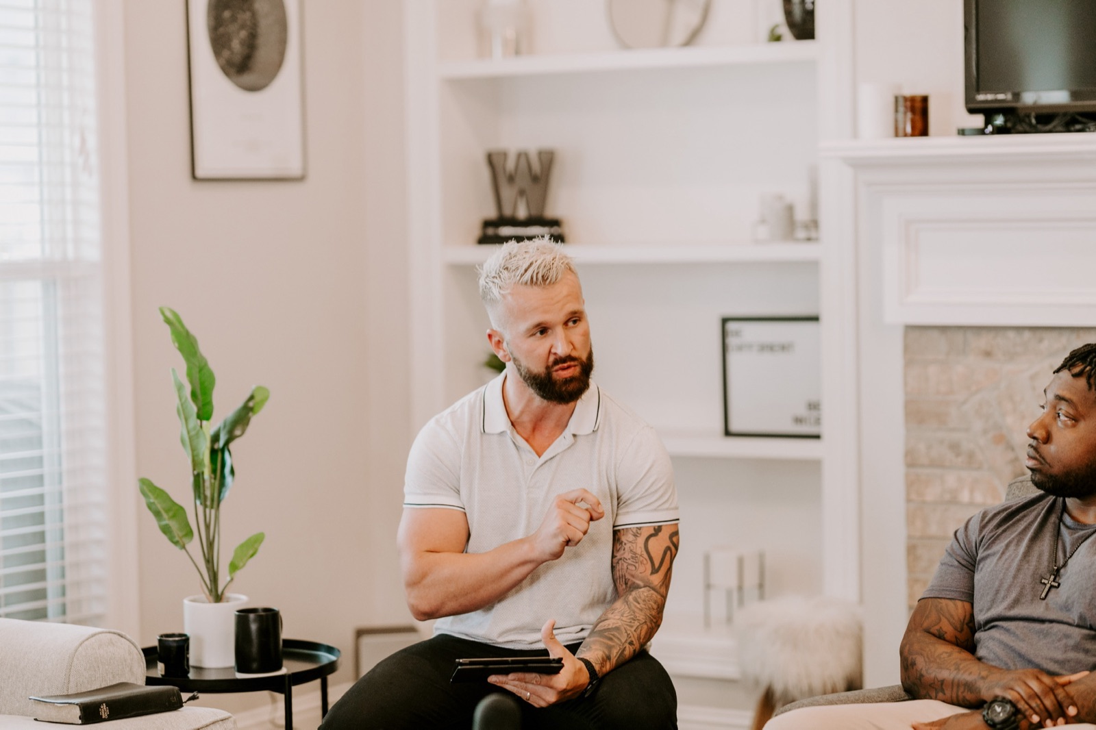 Tyler coaching a small group in a living room